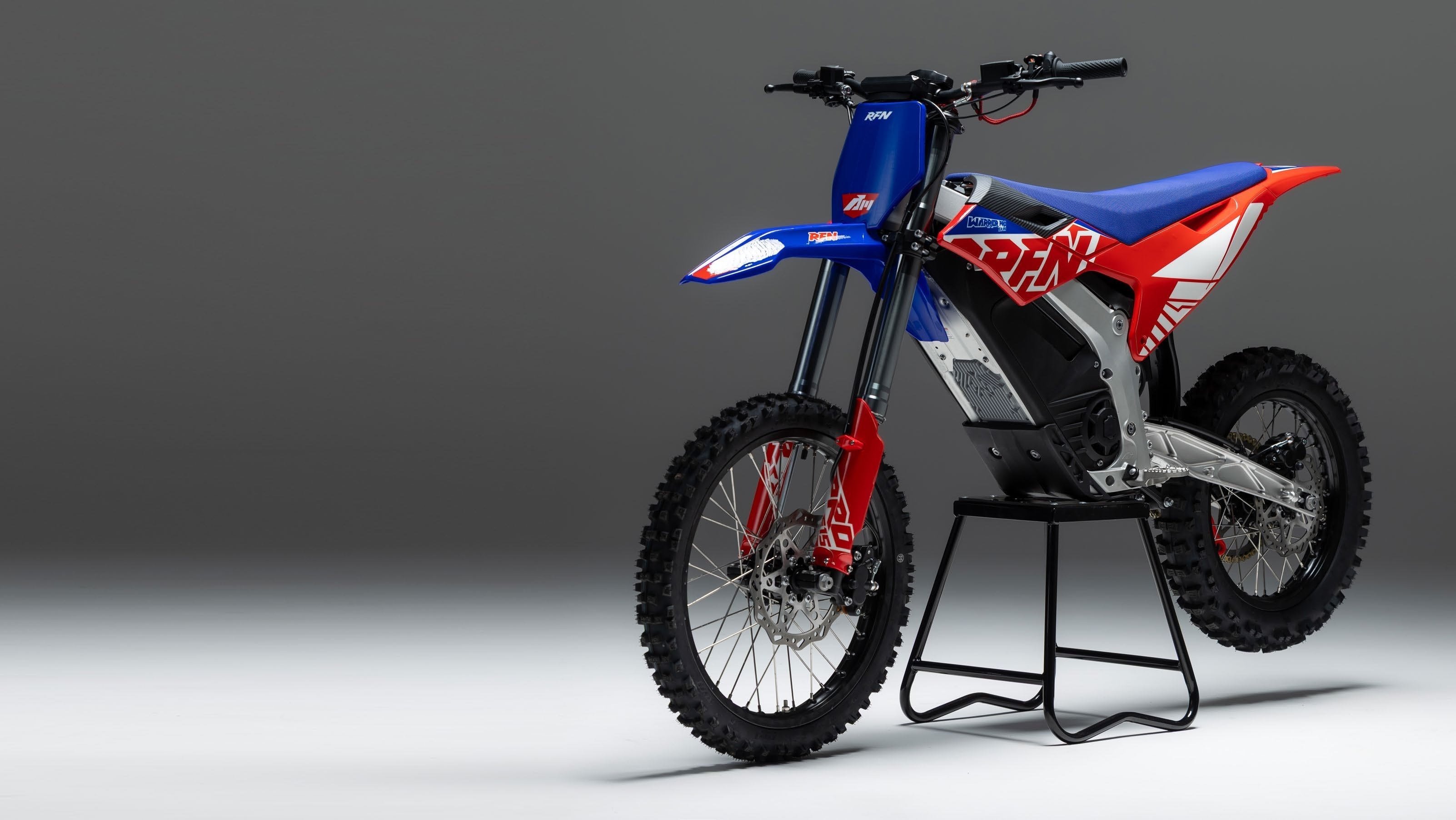 RFN Warrior electric dirt bike in official red and blue livery